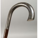 A BAMBOO TYPE WALKING STICK with niello silver handles, 38ins long.