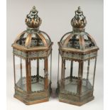 A PAIR OF CIRCULAR METAL AND GLASS LANTERNS, 24ins high.