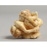 A CARVED BONE EROTIC NETSUKE.