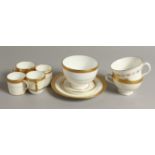 FOUR MINTON COFFEE CUPS, A SAUCER, TWO TEACUPS, ONE WITH A CREST, a sugar bowl and a side plate