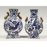 A SMALL PAIR OF CHINESE CLOISONNE MOON VASES, decorated with birds in blue. 3.75ins high.