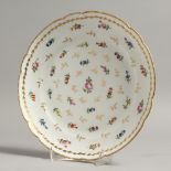 AN 18TH CENTURY CLIGNANCOURT PORCELAIN DISH painted with repeating flower sprigs.