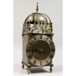 AN 18TH CENTURY BRASS LANTERN CLOCK of typical form, with bell, silvered chapter ring and engraved