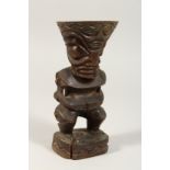 A CARVED WOOD TRIBAL FIGURE TIKI. 8ins high.