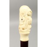 A CARVED BONE HANDLED WALKING STICK, carved with a rat, 35ins long.
