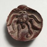 A CARVED WOOD OCTOPUS NETSUKE