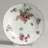 AN 18TH CENTURY CHELSEA PLATE painted with flowers in Meissen style, red anchor mark.