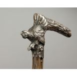 A GOOD 19TH CENTURY RUSTIC WALKING STICK, the silver handle with a pheasant and a branch. 34ins
