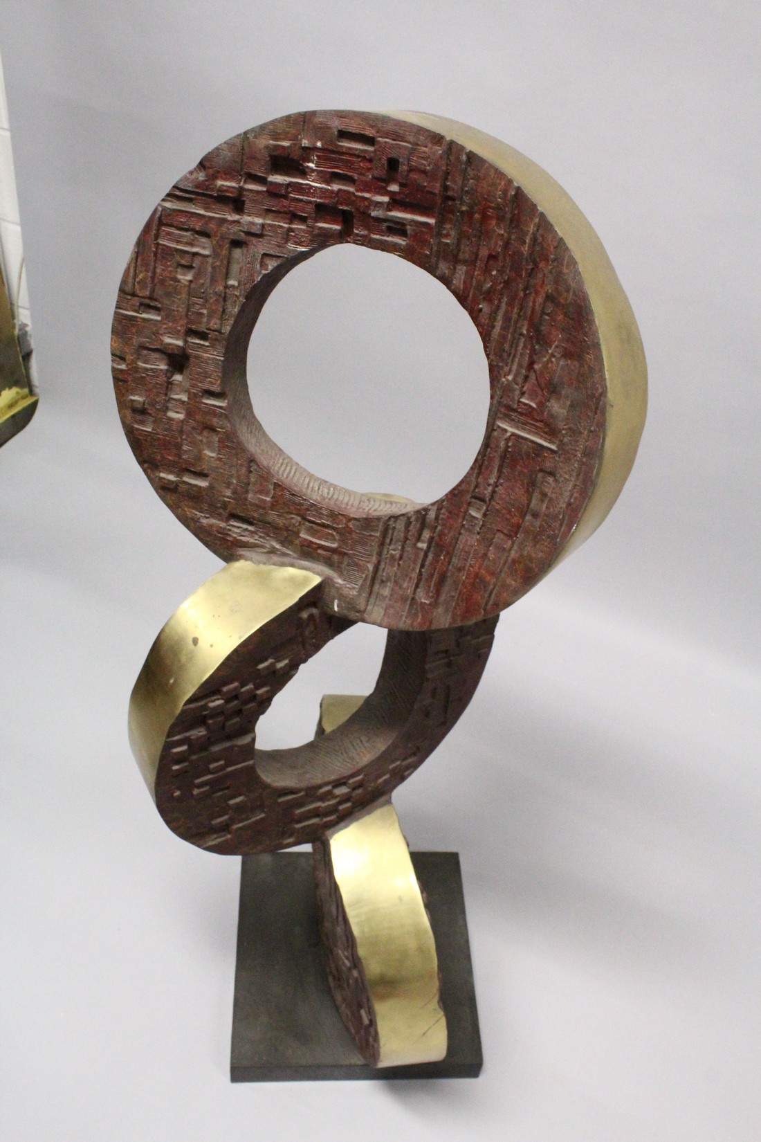 A LARGE BRONZE ABSTRACT MODEL, three rings on a square base. 4ft high. - Image 2 of 3