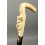 A GOOD 19TH CENTURY AMERICAN WALKING STICK, the ivory handle carved with a dog's head carrying a