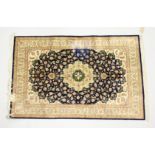 A PERSIAN SILK QUOM RUG, blue ground with all over floral decoration. 4ft 10ins x 3ft 1ins.