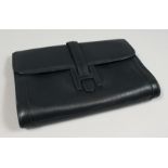 A NAVY LEATHER CLUTCH BAG. 11.5ins x 8ins.