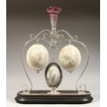 A SUPERB AUSTRALIAN CENTREPIECE, a plated stand with three carved emu egg; aborigine, emu and