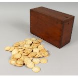 A BAG OF COUNTERS 1.25ins in a wooden box. .