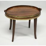A GEORGIAN MAHOGANY OVAL TWO HANDLED TEA TRAY with brass banding, on a later stand with curving