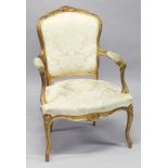 A LATE 19TH CENTURY / EARLY 20TH CENTURY FRENCH GILTWOOD FAUTEUIL, upholstered in a classical