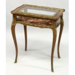 A GOOD 19TH CENTURY FRENCH ROSEWOOD BIJOUTERIE TABLE with ornate mounts, lift-up glazed top, glass