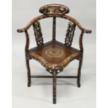 A CHINESE ROSEWOOD AND MOTHER OF PEARL CORNER CHAIR with solid seat.