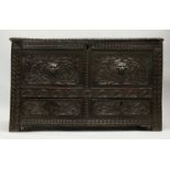 AN 18TH CENTURY OAK COFFER, with a plain plank top, pair of carved panels to the front, with
