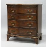 A GEORGE III STYLE MAHOGANY SERPENTINE FRONT CHEST OF DRAWERS, with brushing slide and four