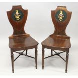 A VERY GOOD PAIR OF 19TH CENTURY MAHOGANY HALL CHAIRS, with shield shaped backs having a painted and