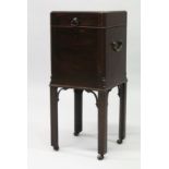 A GEORGE III MAHOGANY CELLARETTE, the hinged top opening to reveal four lead lined compartments, the
