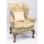 A GOOD GEORGE II DESIGN WALNUT AND UPHOLSTERED WING ARMCHAIR, with floral upholstery on four well