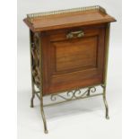 AN EDWARDIAN MAHOGANY RECTANGULAR MAGAZINE RACK with brass gallery, fold down front with three