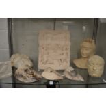 A collection of plaster plaques, wall masks etc.
