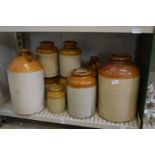 A quantity of stoneware flagons and jars.