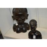 Two carved African busts.