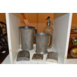 Large pewter tankards and other items.