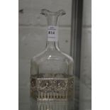 A silver mounted engraved glass bottle.