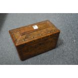 A Victorian figured walnut sarcophagus shaped tea caddy.