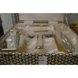 A sterling silver four-piece dressing table set, boxed.