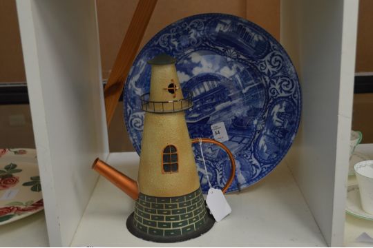 A commemorative plate and a novelty teapot.