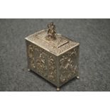 An Indian white metal tea caddy with hinged cover and embossed decoration.