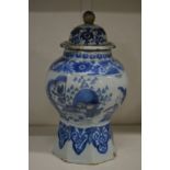A blue and white jar and cover.