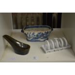 A blue and white dish and two other items.