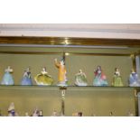 A group of eight Royal Doulton figurines.