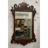 A fretwork wall mirror.