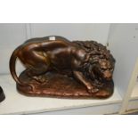 A bronzed plaster model of a lion.