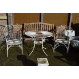 A white painted wirework circular garden table and pair of armchairs.