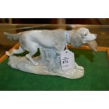 An unusual Lladro model of a retriever with a bird in its mouth.