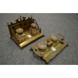 Two decorative brass desk stands with cut glass inkwells.