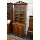 A Victorian walnut cupboard bookcase.