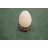 A model of an egg on stand.