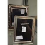 A silver photograph frame and another frame.