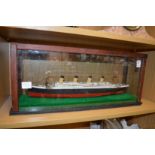 A cased model of a steam ship.