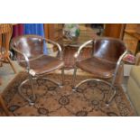 A pair of stylish steel framed and brown leather upholstered cantilever armchairs.